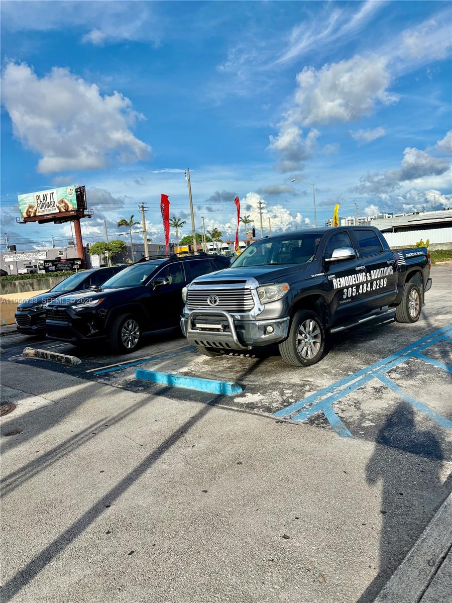 A dark pickup truck and a black SUV are parked in a paved outdoor lot — 8401 NW South River Dr, Medley FL 33166, MEDLEY, FL