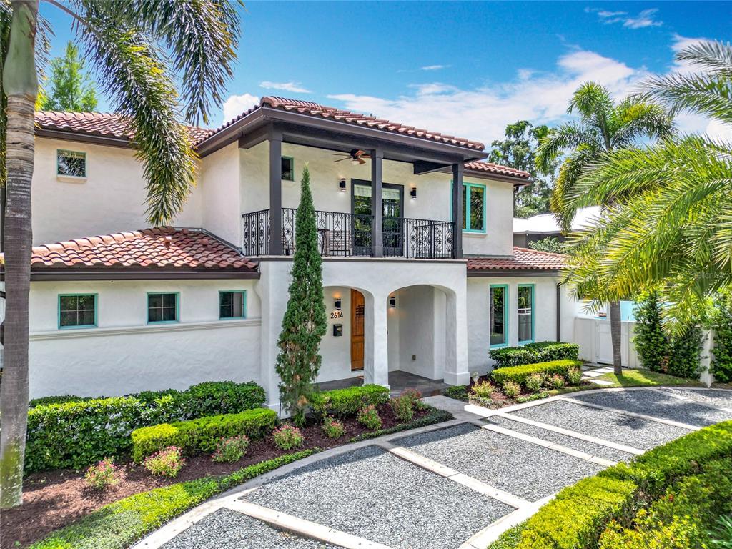 A two-story white stucco house with a red tile roof and a gravel driveway — 2614 PARKLAND DRIVE, WINTER PARK, FL