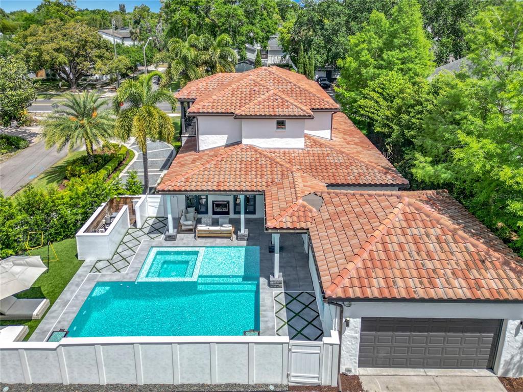 An aerial view of a house with a tile roof, swimming pool, and patio area — 2614 PARKLAND DRIVE, WINTER PARK, FL