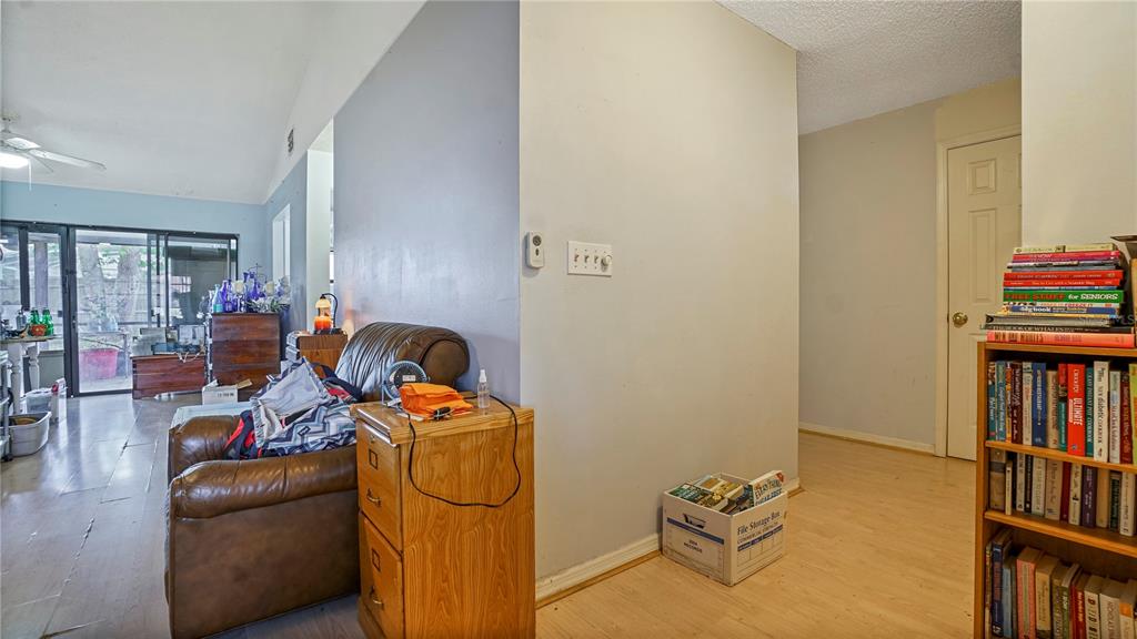 A living area features a leather armchair, a wooden filing cabinet, and a bookshelf — 774 HARLAND COURT, KISSIMMEE, FL