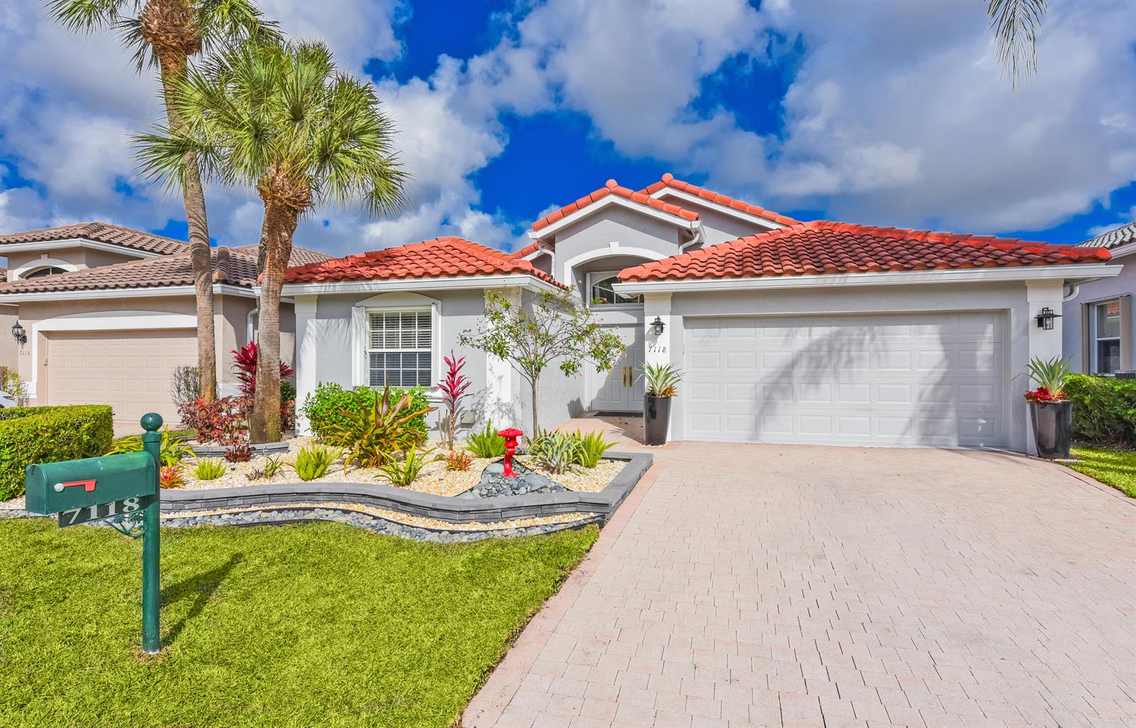 A single-story house with a red tile roof, a paved driveway, and a green mailbox — 7118 Treviso Lane, Boynton Beach FL 33472, BOYNTON BEACH, FL