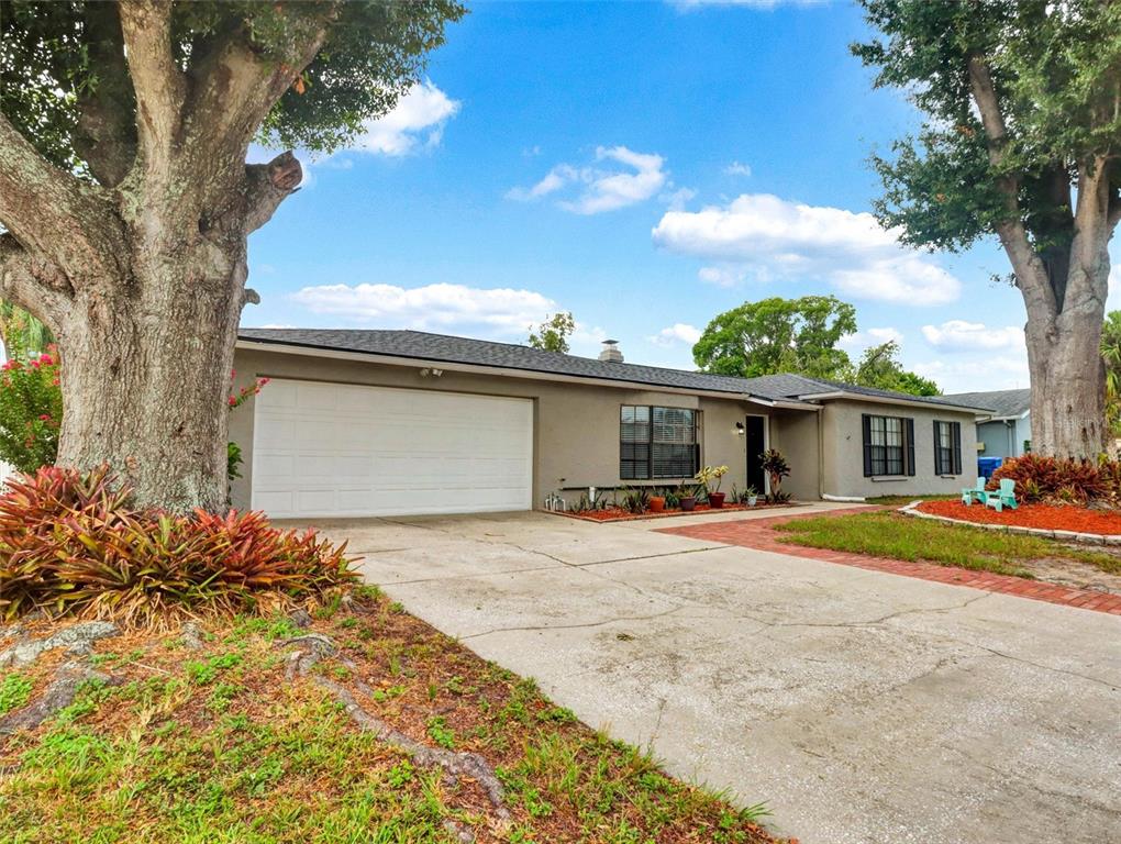 This is a virtually staged living room with a sofa, coffee table, and television console — 13346 MORAN DRIVE, TAMPA, FL