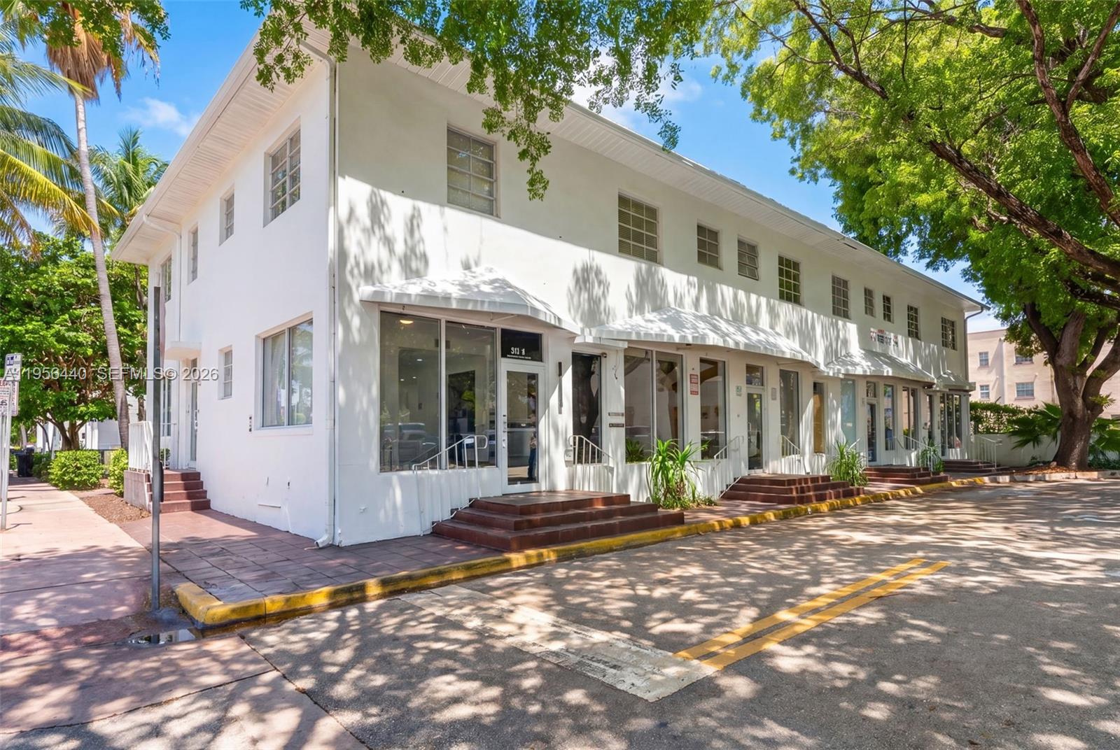 A two-story white commercial building features multiple ground-level storefront entrances with steps and awnings — 901 Pennsylvania Ave, Miami Beach FL 33139, MIAMI BEACH, FL