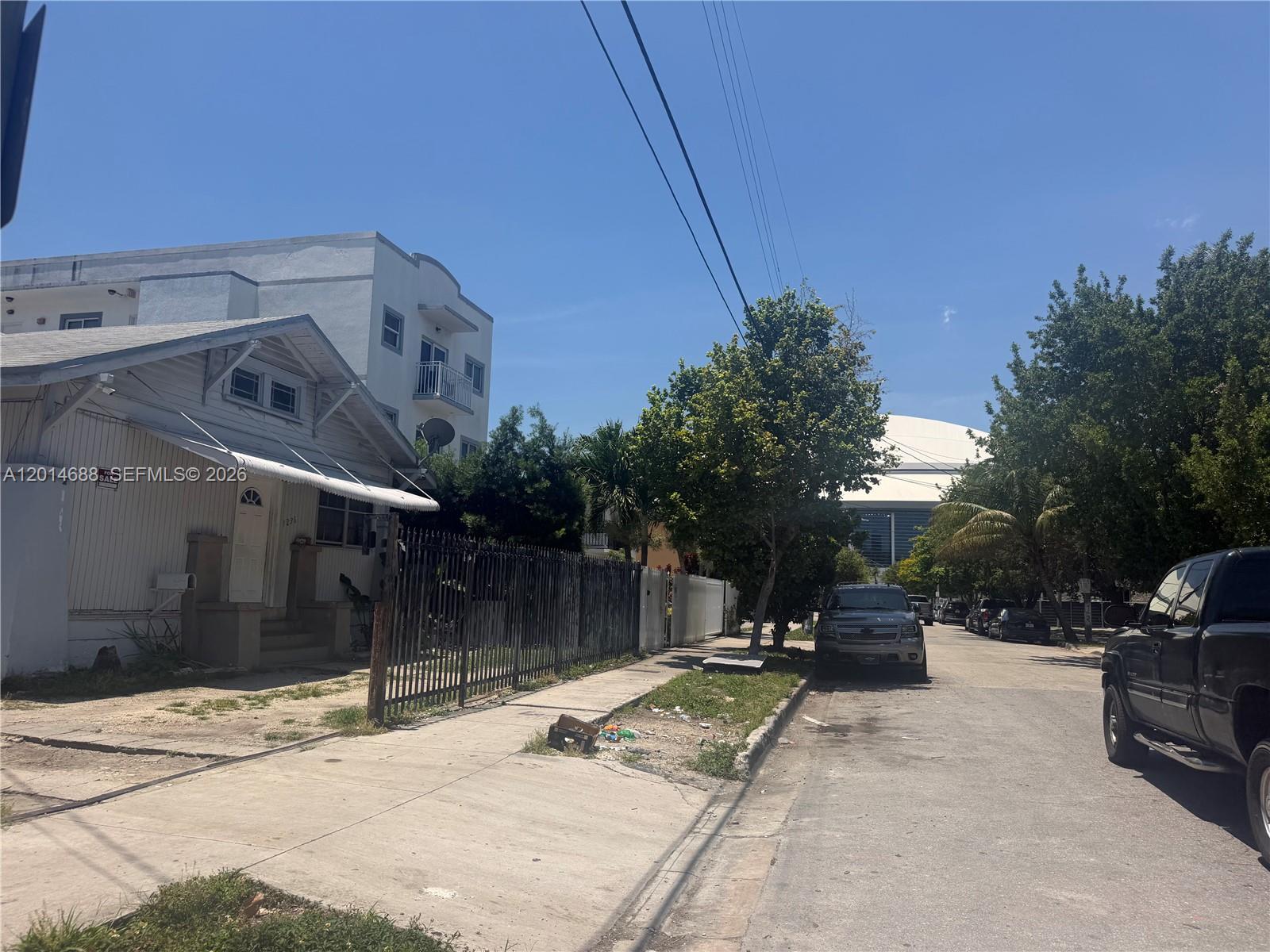 A street view shows a white house with a metal fence next to parked cars — 1236 NW 5th St, Miami FL 33125, MIAMI, FL