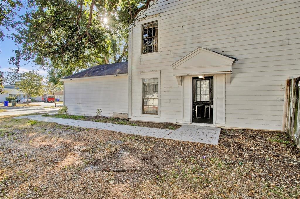 The exterior of a two-story white house features a black front door and sidewalk — 1817 CRYSTAL GROVE DRIVE, LAKELAND, FL