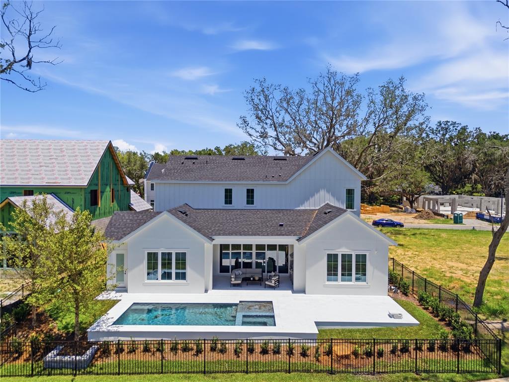 An aerial view of a white two-story house with a swimming pool and fenced backyard — 1134 PRADO LANE, OAKLAND, FL