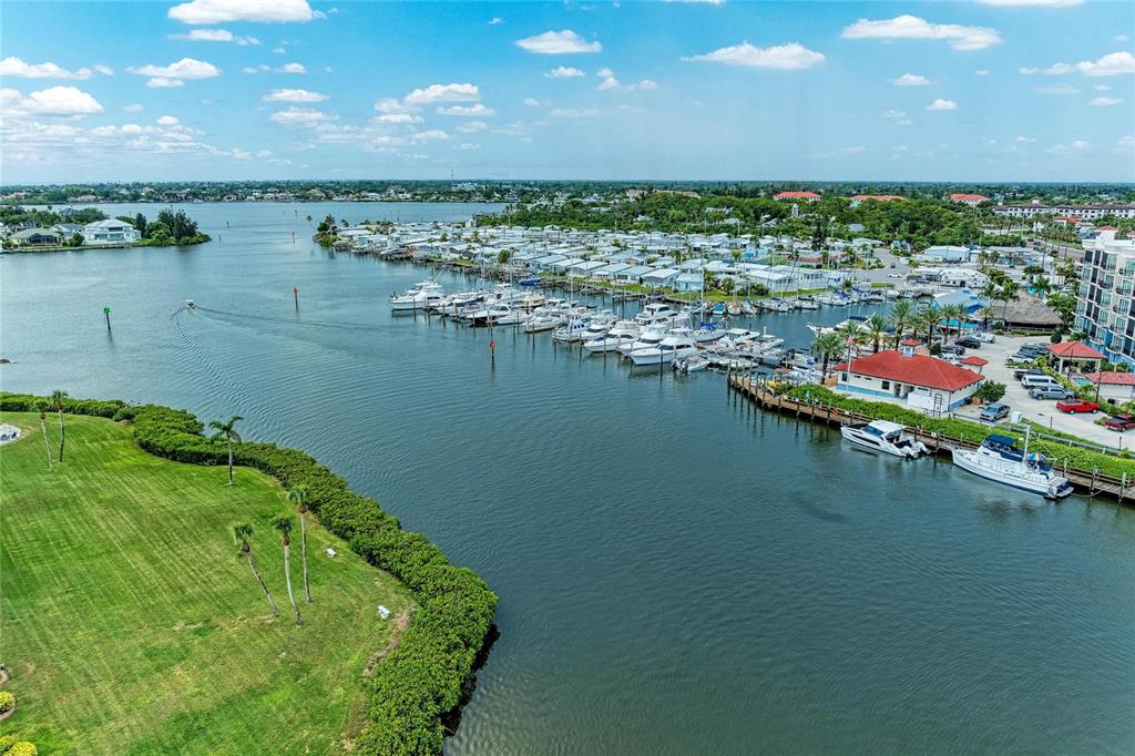 An aerial view shows a marina with numerous boats docked near a residential area — 220 SANTA MARIA STREET UNIT 338, VENICE, FL