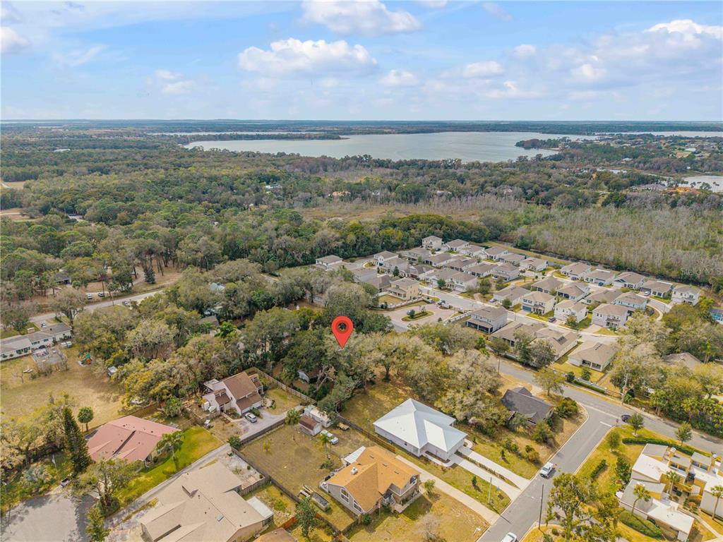An aerial view shows a residential neighborhood with a red location pin over a house — 0 S CLAYTON STREET, MOUNT DORA, FL