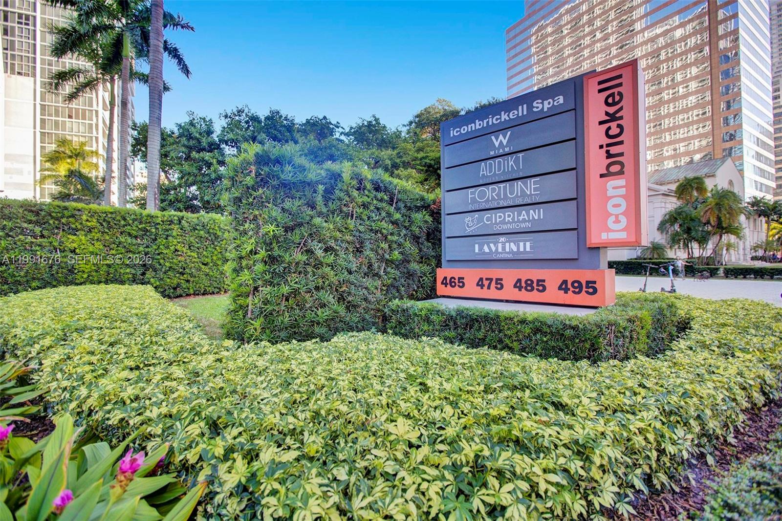 A directory sign for icon brickell stands in front of a landscaped hedge and buildings — 475 Brickell Ave # 5010, Miami FL 33131, MIAMI, FL