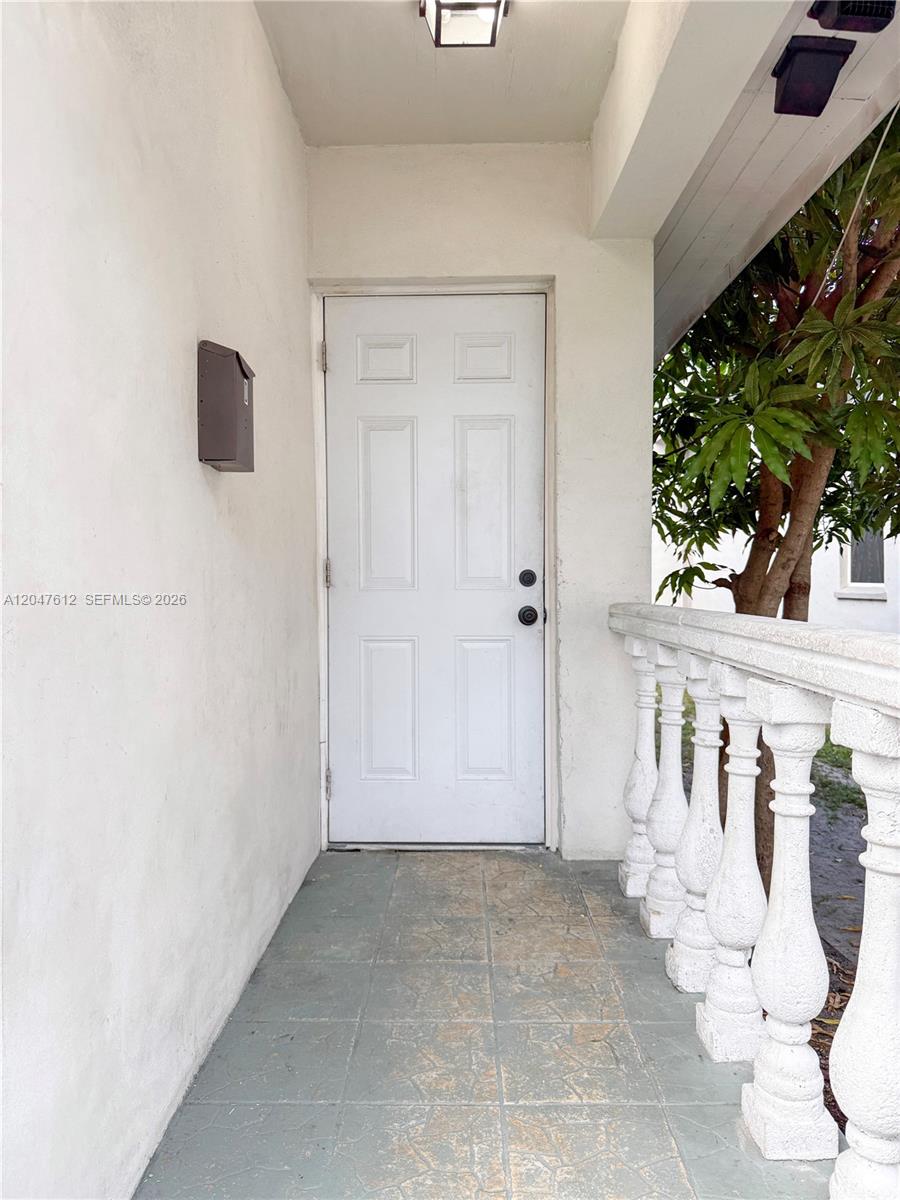 A white door with a black mailbox sits on a tiled porch with balustrades — 2 SW 6th Ave # 4, Dania Beach FL 33004, DANIA BEACH, FL