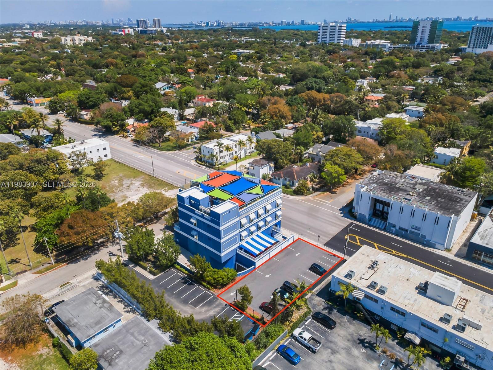 An aerial view shows a blue multi-story building with a parking lot outlined in red — 4128 N Miami Ave, Miami FL 33127, MIAMI, FL