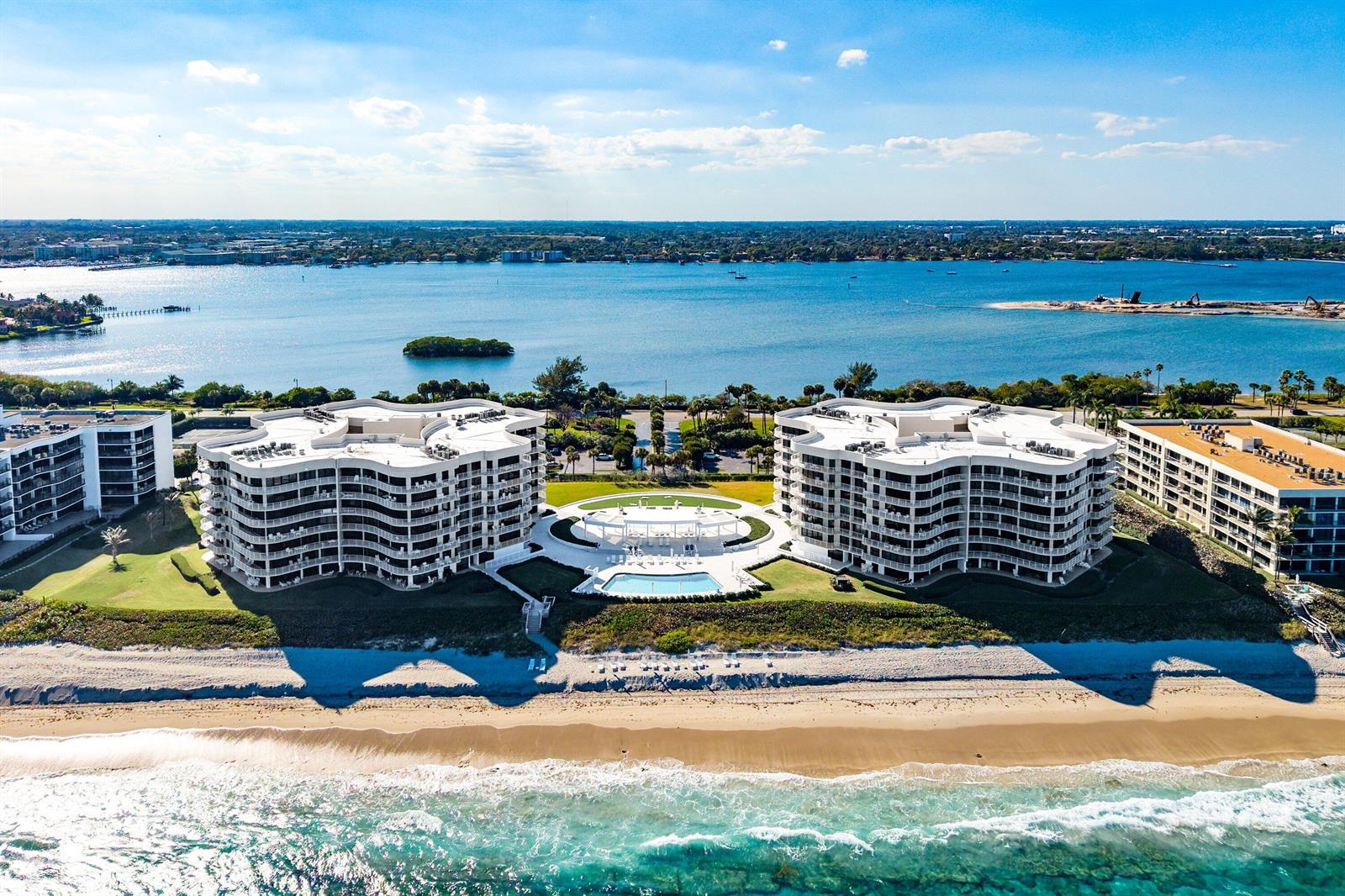 Aerial view of two curved beachfront condominium buildings with a central pool and patio area — 3400 S Ocean Boulevard, Palm Beach FL 33480, PALM BEACH, FL