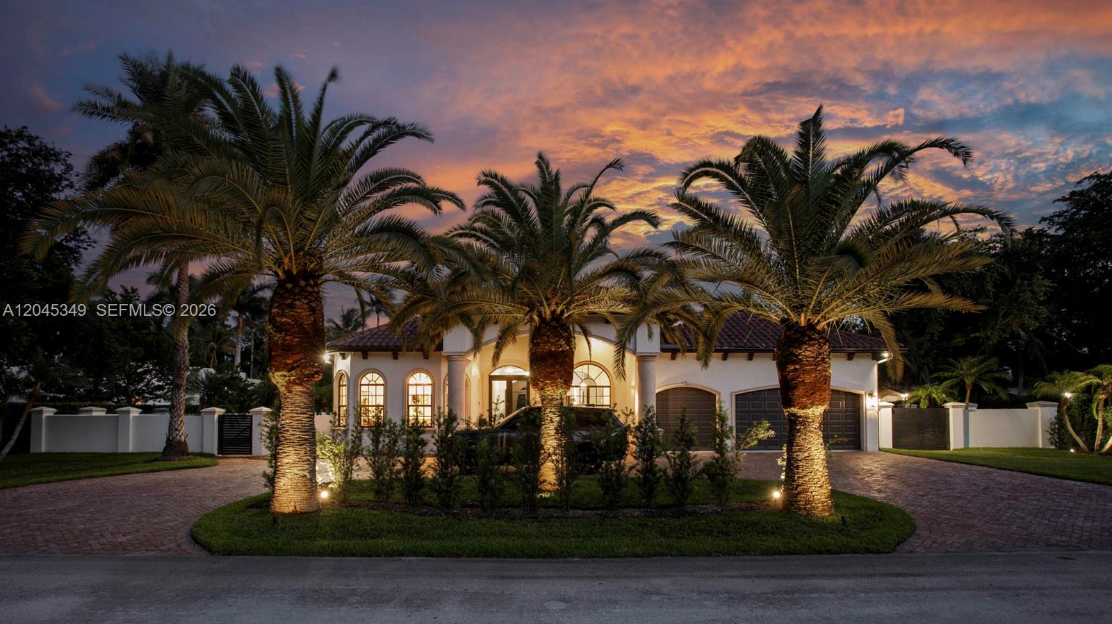 A single-story house with a brick driveway and three palm trees at dusk — 6874 SW 57th Ter, Miami FL 33143, MIAMI, FL