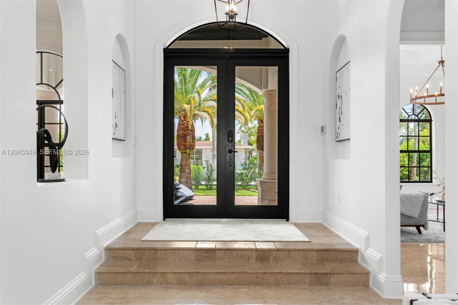 A bright entryway features a double glass door, arched wall niches, and stone steps — 6874 SW 57th Ter, Miami FL 33143, MIAMI, FL