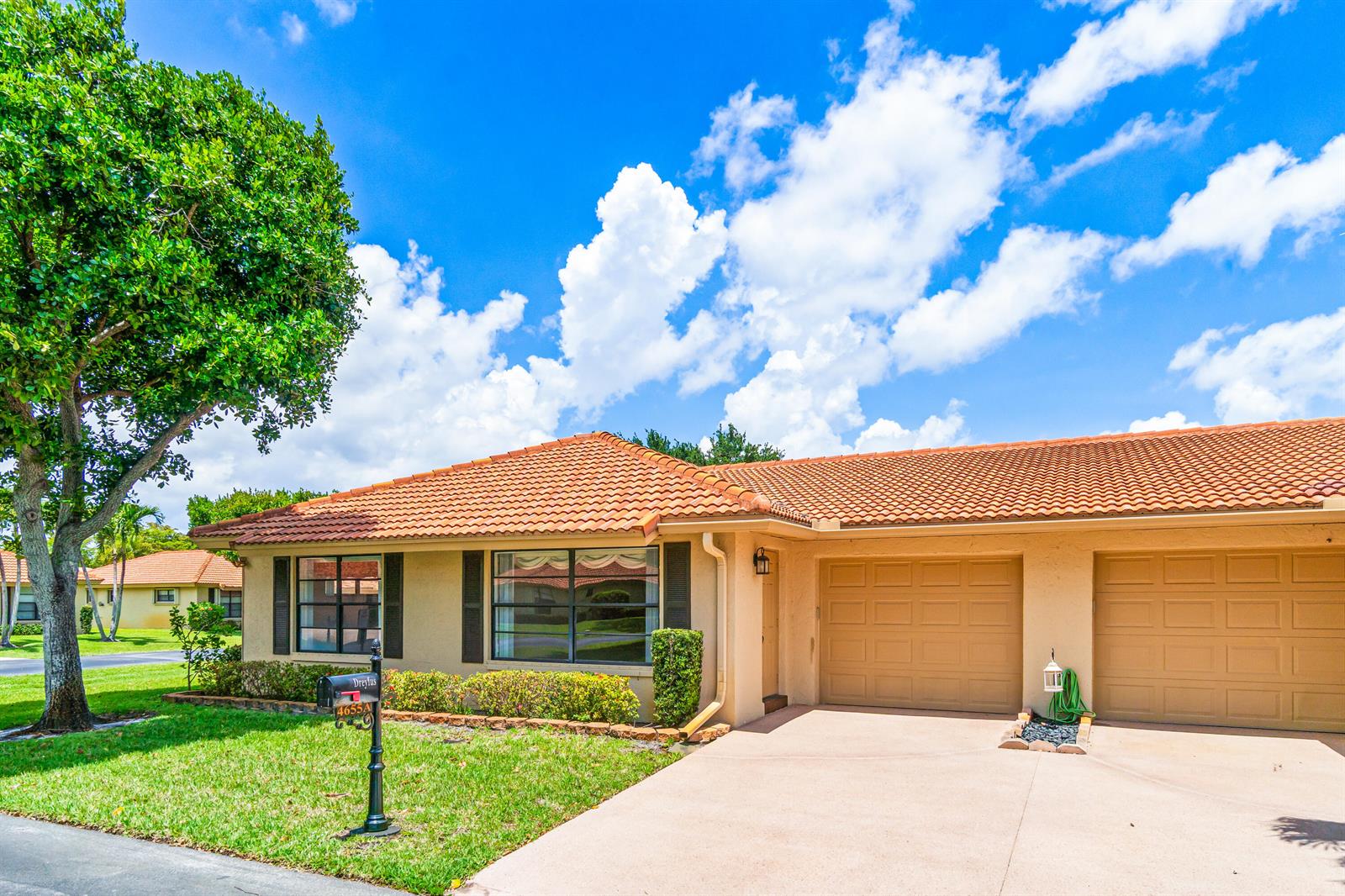 A single-story house with a tile roof, tan stucco exterior, and a two-car garage — 4655 Mahoe Tree Place # A, Boynton Beach FL 33436, BOYNTON BEACH, FL