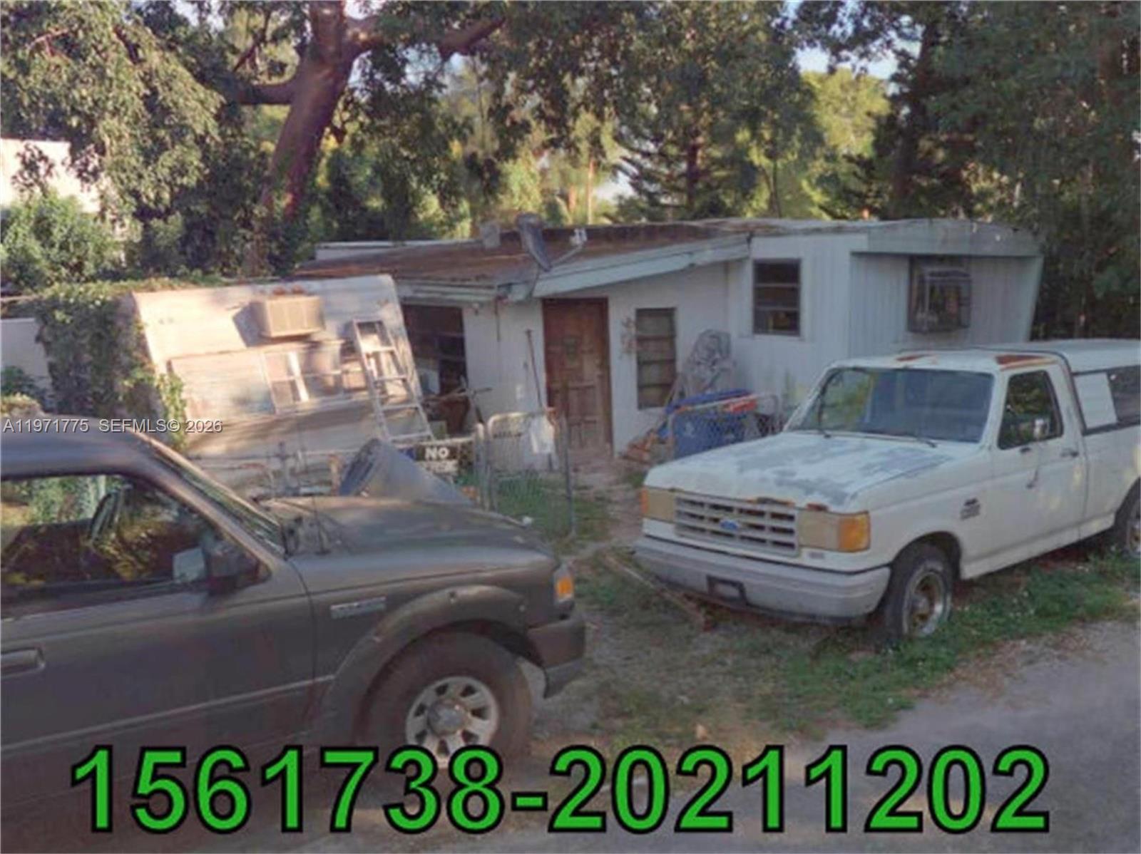 A small, weathered house with two parked trucks in the front yard — 2 Janet Pl, Key Largo FL 33037, KEY LARGO, FL