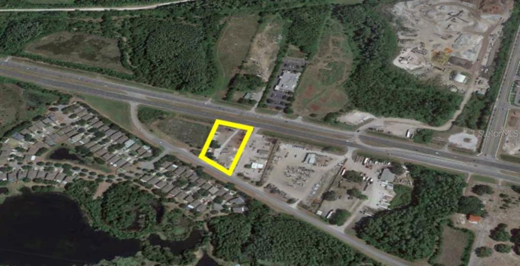 This aerial map shows a vacant lot outlined in yellow along a highway — 14024 STATE ROAD 54, ODESSA, FL