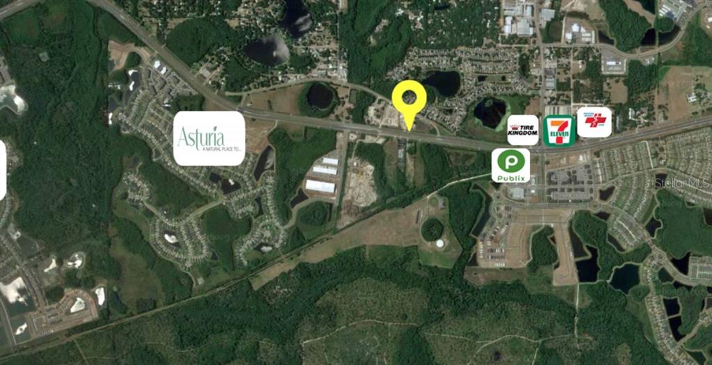 This aerial map shows a residential area with nearby businesses and a yellow location marker — 14024 STATE ROAD 54, ODESSA, FL