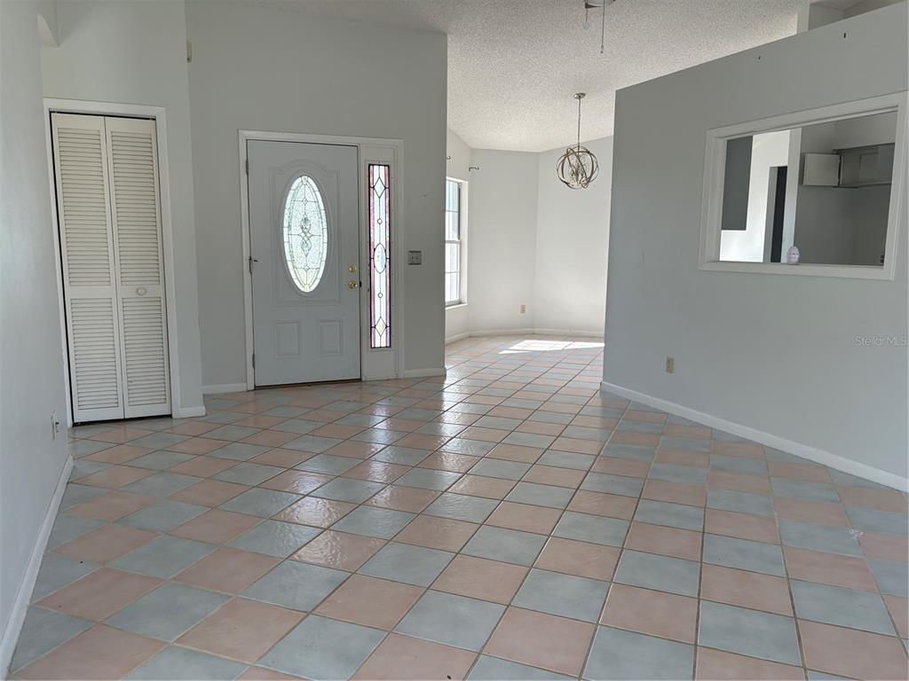 An entryway with light-colored tile flooring leads to a front door and an adjacent room — 4422 N RATH RUE POINT, BEVERLY HILLS, FL