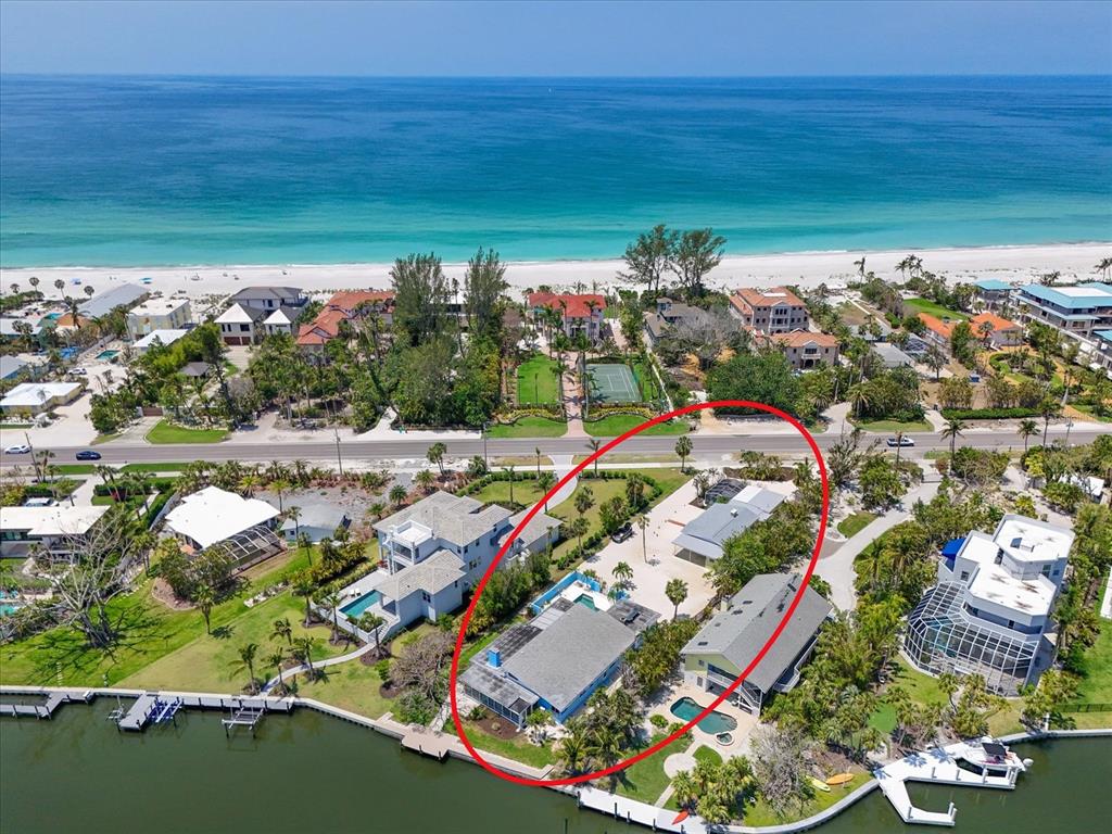 Aerial view of two waterfront houses with pools and docks along a canal — 5924 GULF OF MEXICO DRIVE, LONGBOAT KEY, FL