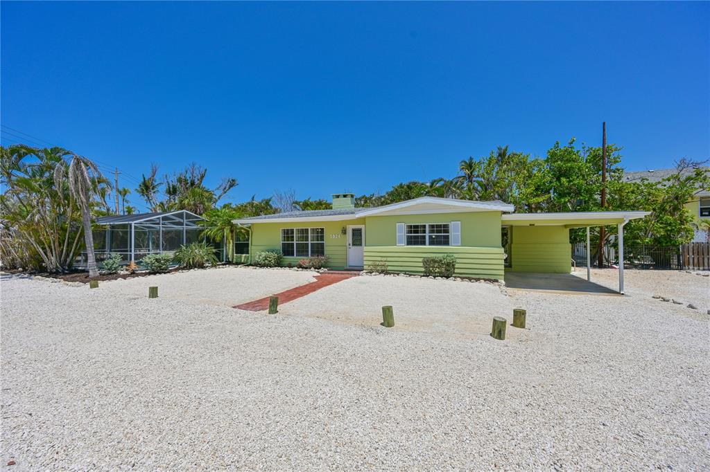 A light green, single-story house with a gravel yard and a covered carport — 5924 GULF OF MEXICO DRIVE, LONGBOAT KEY, FL