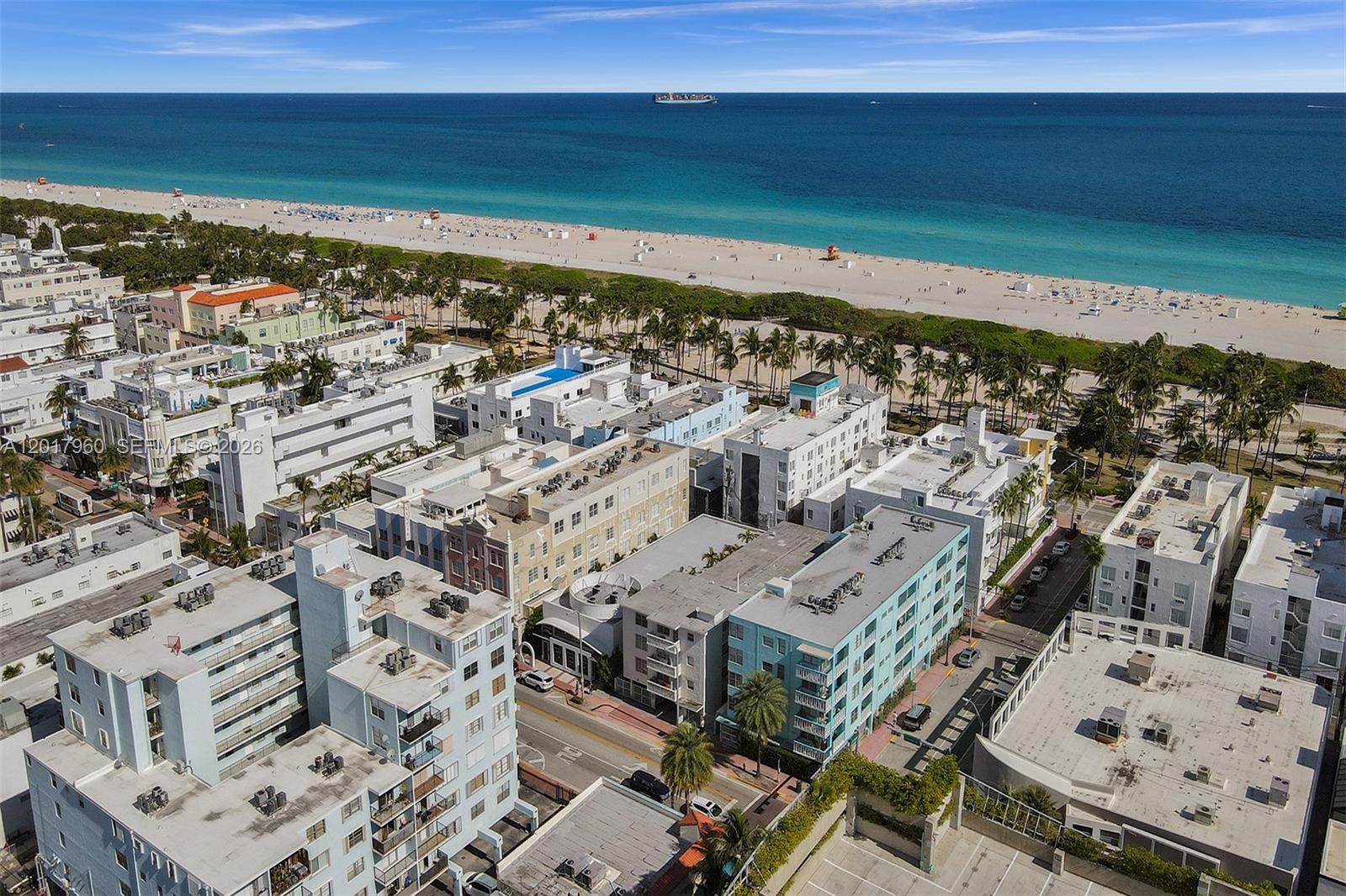An aerial view shows multiple low-rise apartment buildings located near a sandy beach and ocean — 713 Collins Ave # 42, Miami Beach FL 33139, MIAMI BEACH, FL