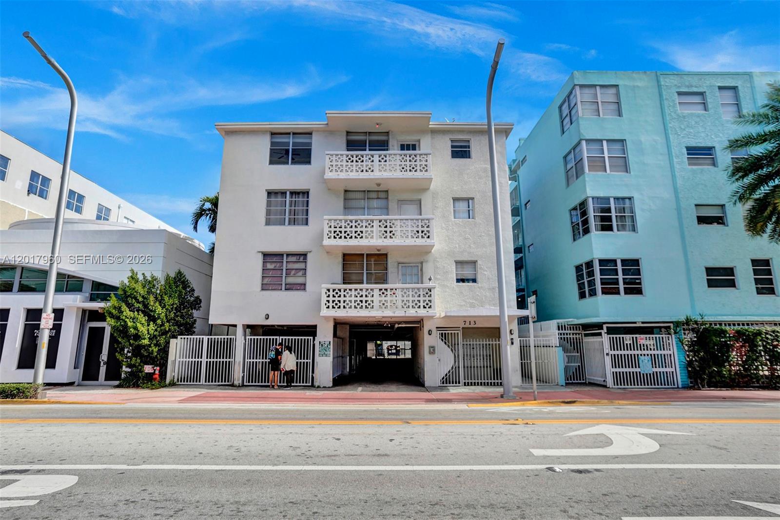 A three-story white apartment building stands between two other buildings along a city street — 713 Collins Ave # 42, Miami Beach FL 33139, MIAMI BEACH, FL