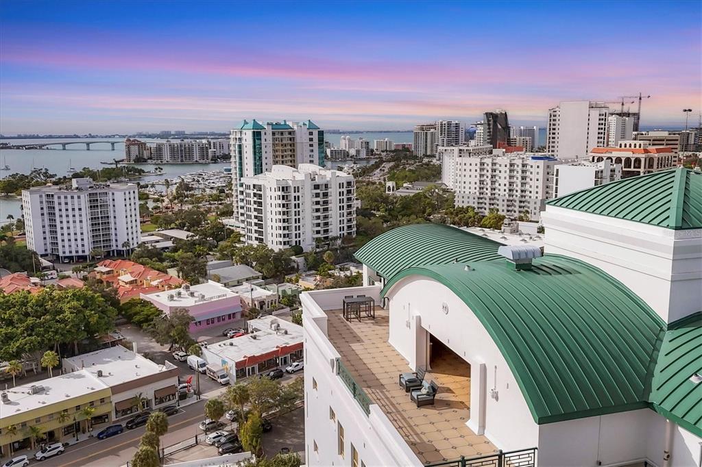 An exterior view of a multi-story residential building with balconies under a starry night sky — 505 S ORANGE AVENUE UNIT 301, SARASOTA, FL