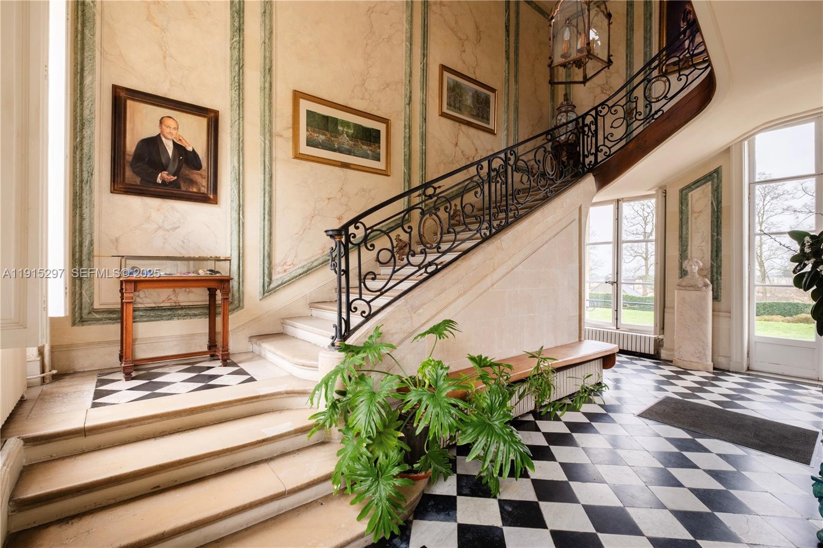 A grand foyer features a stone staircase with iron railings and a black-and-white checkered floor — 53 Route de Saint-Germain, TX 78860, TX
