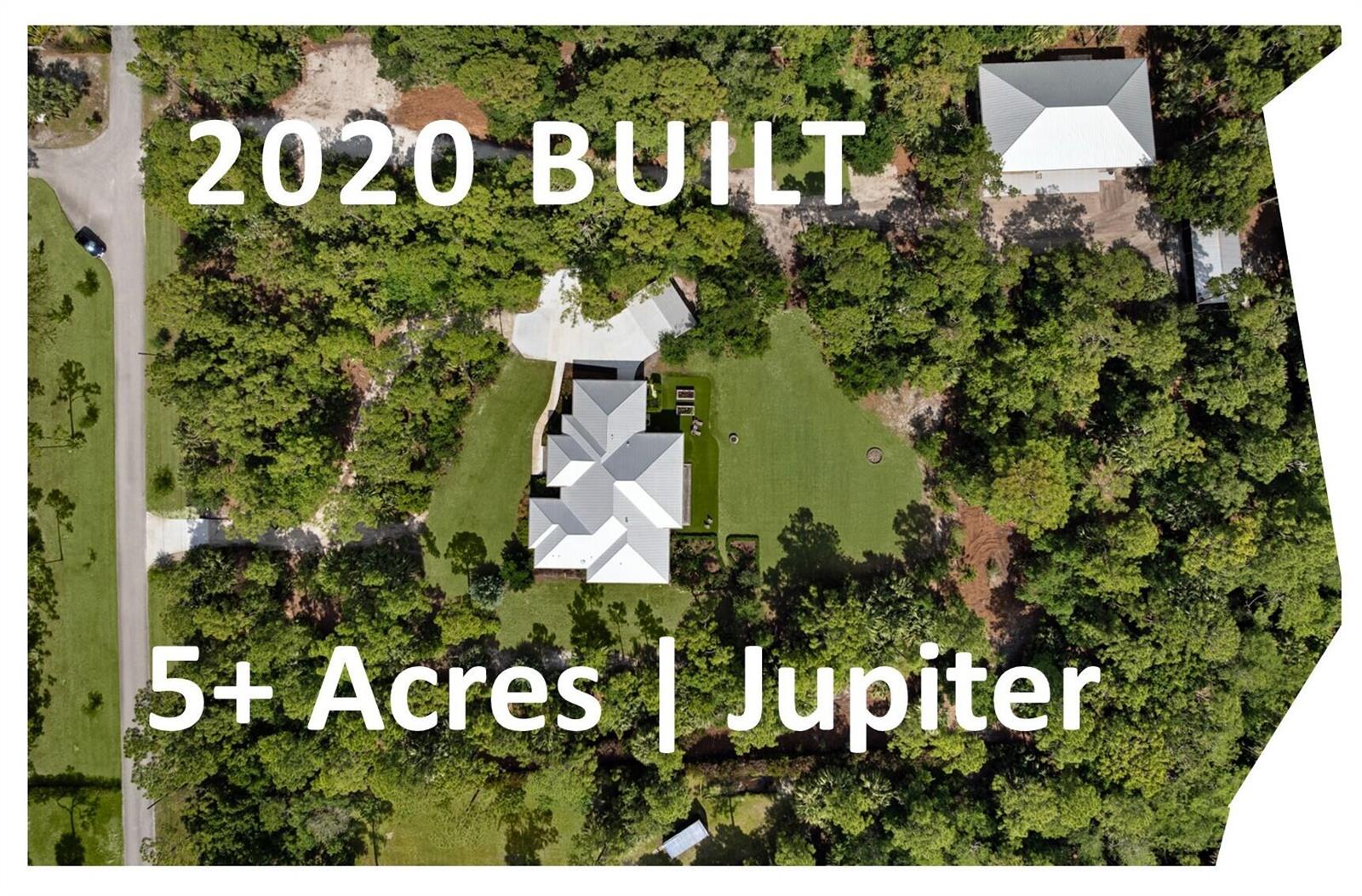 An aerial view shows a house and detached garage on a large, wooded five-acre lot — 9010 Valley Oak Place, Jupiter FL 33478, JUPITER, FL