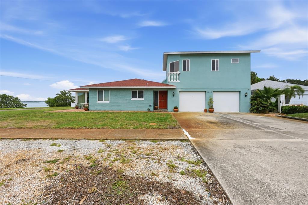 A two-story light blue house with a red roof and a two-car garage — 1963 EDGEWATER DRIVE, CLEARWATER, FL