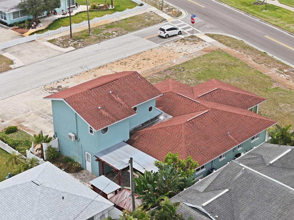 An aerial view of a two-story teal house with a red shingled roof — 1963 EDGEWATER DRIVE, CLEARWATER, FL