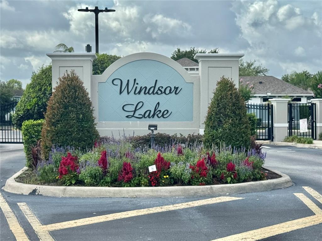 A stone monument sign for Windsor Lake stands in a landscaped traffic island — 3141 WINDLESHORE WAY, SANFORD, FL