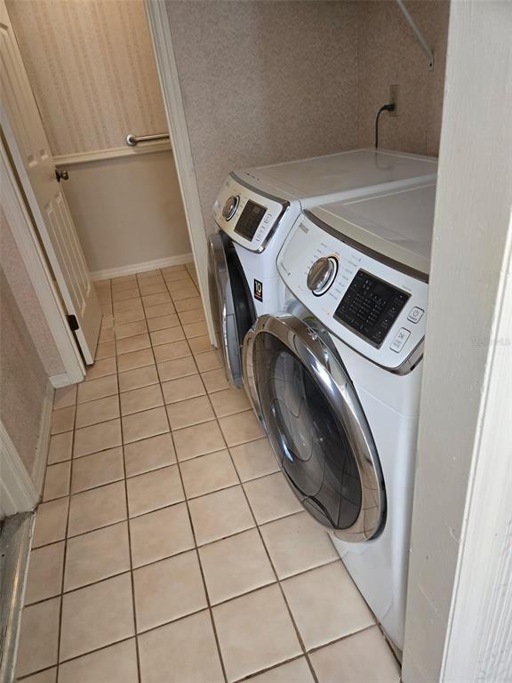 A laundry closet features a side-by-side washer and dryer on a tiled floor — 4343 NW 80TH AVENUE UNIT 2, OCALA, FL