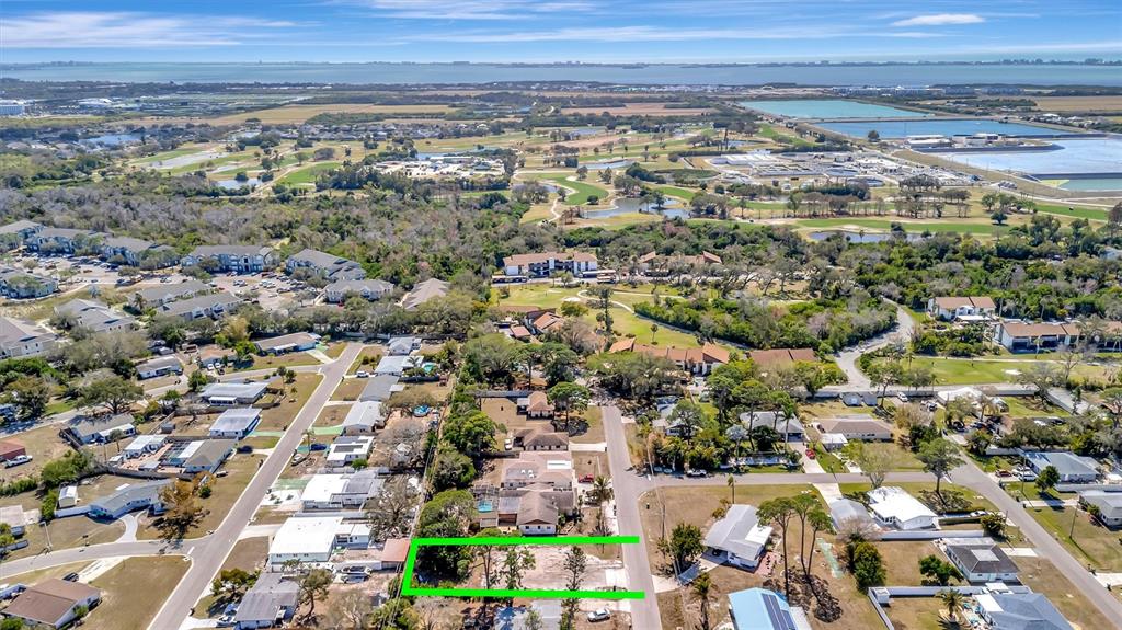 An aerial view shows a vacant rectangular lot outlined in green within a suburban neighborhood — 4519 60TH STREET W, BRADENTON, FL