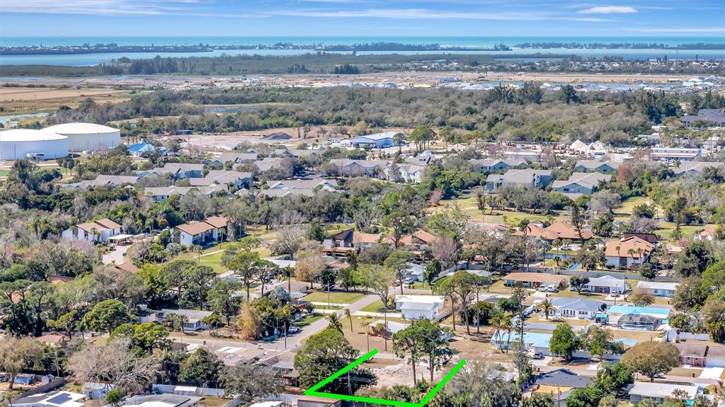 An aerial view shows a vacant residential lot outlined in green within a suburban neighborhood — 4519 60TH STREET W, BRADENTON, FL