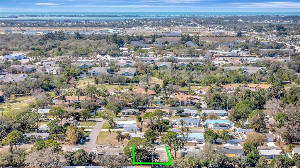 An aerial view shows a vacant residential lot outlined in green within a suburban neighborhood — 4519 60TH STREET W, BRADENTON, FL