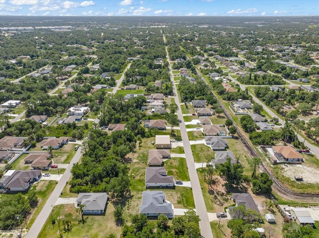An aerial view of a suburban neighborhood with single-family homes and tree-lined streets — WOODWARD AVENUE, NORTH PORT, FL