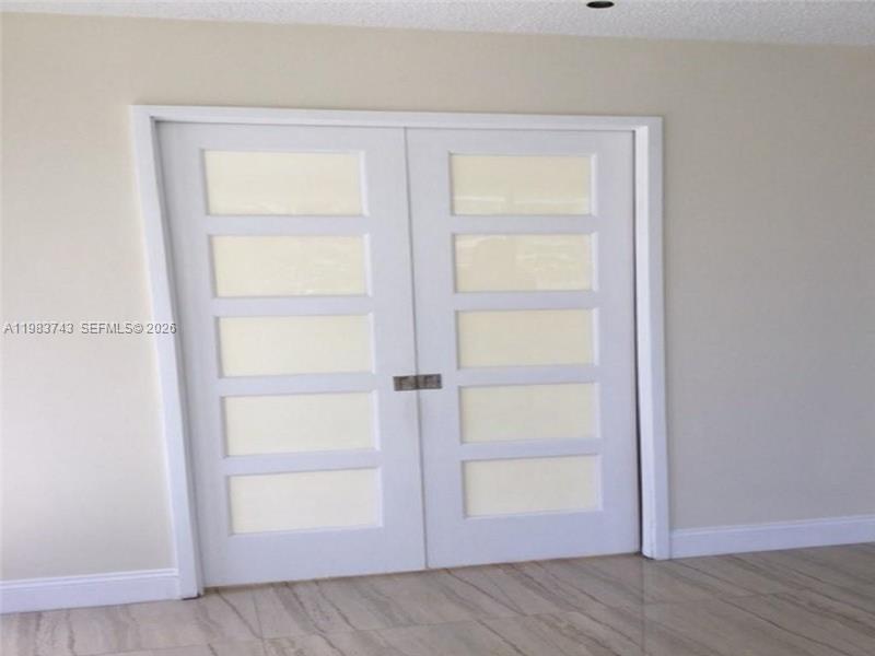 A set of white double doors with five glass panels each is set in a wall — 2049 S Ocean Dr # 210, Hallandale Beach FL 33009, HALLANDALE BEACH, FL