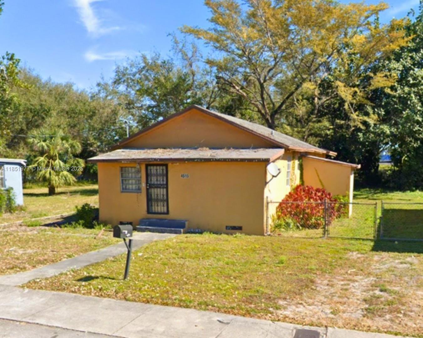 A single-story yellow house with a gabled roof sits on a grassy lot — 4501 NW 33rd Ave, Miami FL 33142, MIAMI, FL