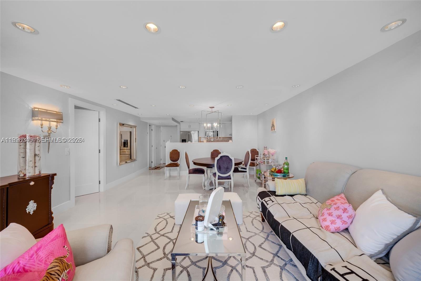 A living room and dining area feature white tile floors, recessed lighting, and neutral walls — 5838 Collins Ave # 2F, Miami Beach FL 33140, MIAMI BEACH, FL