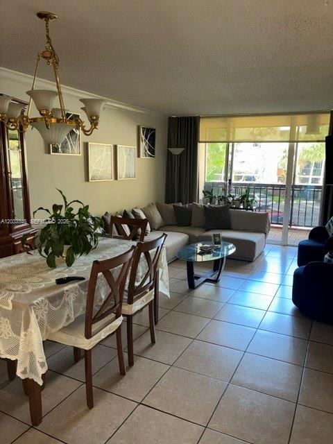 A dining area with a chandelier and a living room with a sectional sofa — 10845 SW 112th Ave, Miami FL 33176, MIAMI, FL