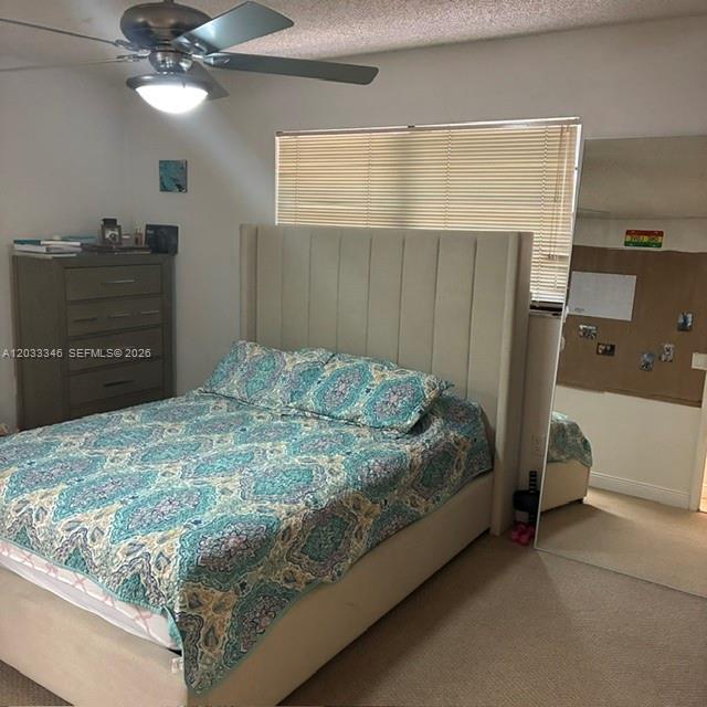 A bedroom features a bed with a tall upholstered headboard, a dresser, and a floor mirror — 10845 SW 112th Ave, Miami FL 33176, MIAMI, FL