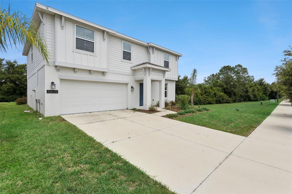 A two-story house with white siding, a two-car garage, and a concrete driveway — 33622 SKY BLOSSOM CIRCLE, LEESBURG, FL