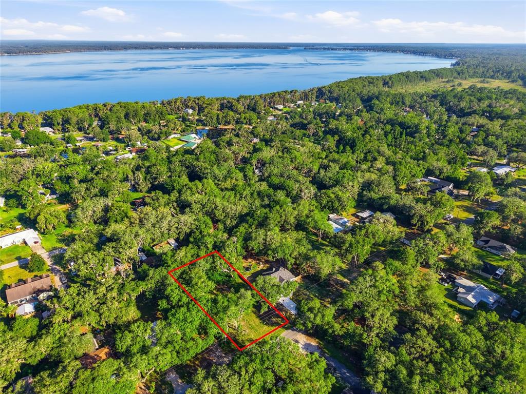 An aerial view shows a rectangular lot outlined in red surrounded by trees and houses — 00 SE 2ND AVENUE, MELROSE, FL