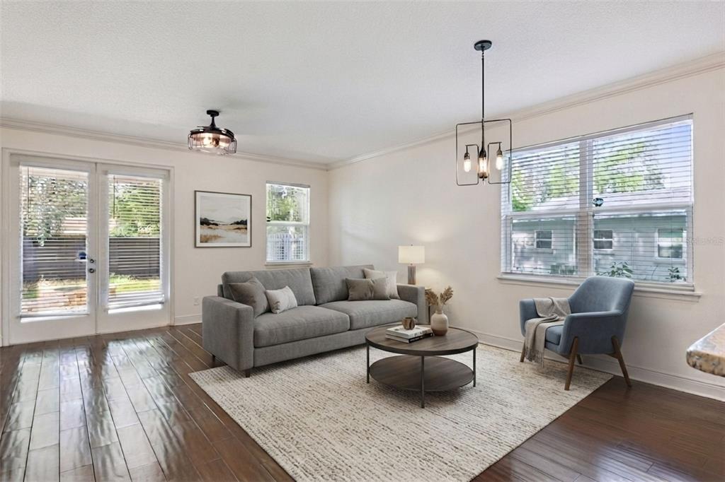 A living room features a gray sofa, a blue armchair, a coffee table, and hardwood floors — 2806 KILGORE STREET, ORLANDO, FL