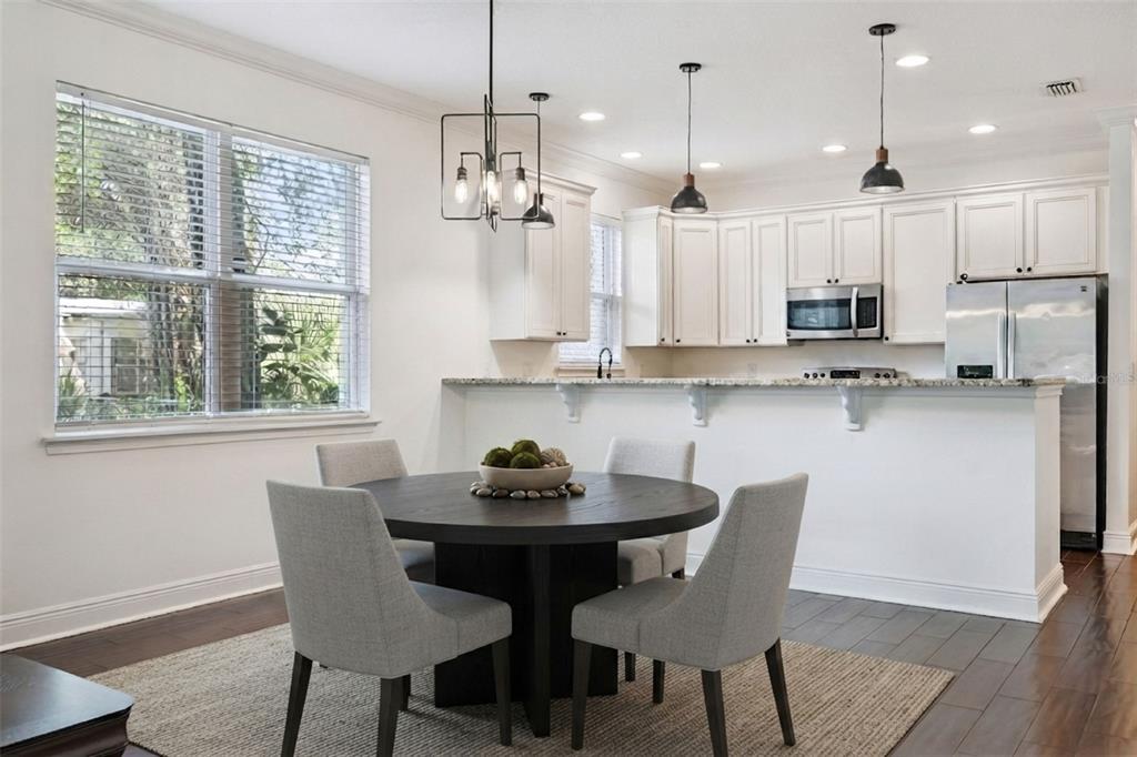 A dining area with a round table and chairs sits in front of a kitchen — 2806 KILGORE STREET, ORLANDO, FL