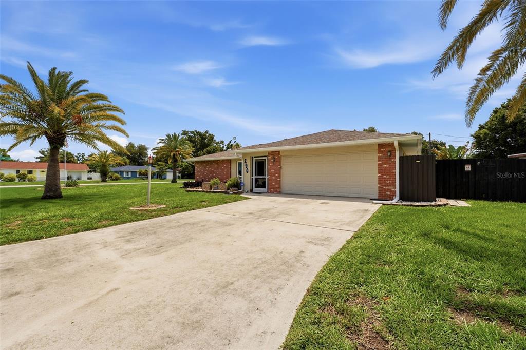 A single-story house with a brick facade, a two-car garage, and a concrete driveway — 290 CAPRI AVENUE, VENICE, FL