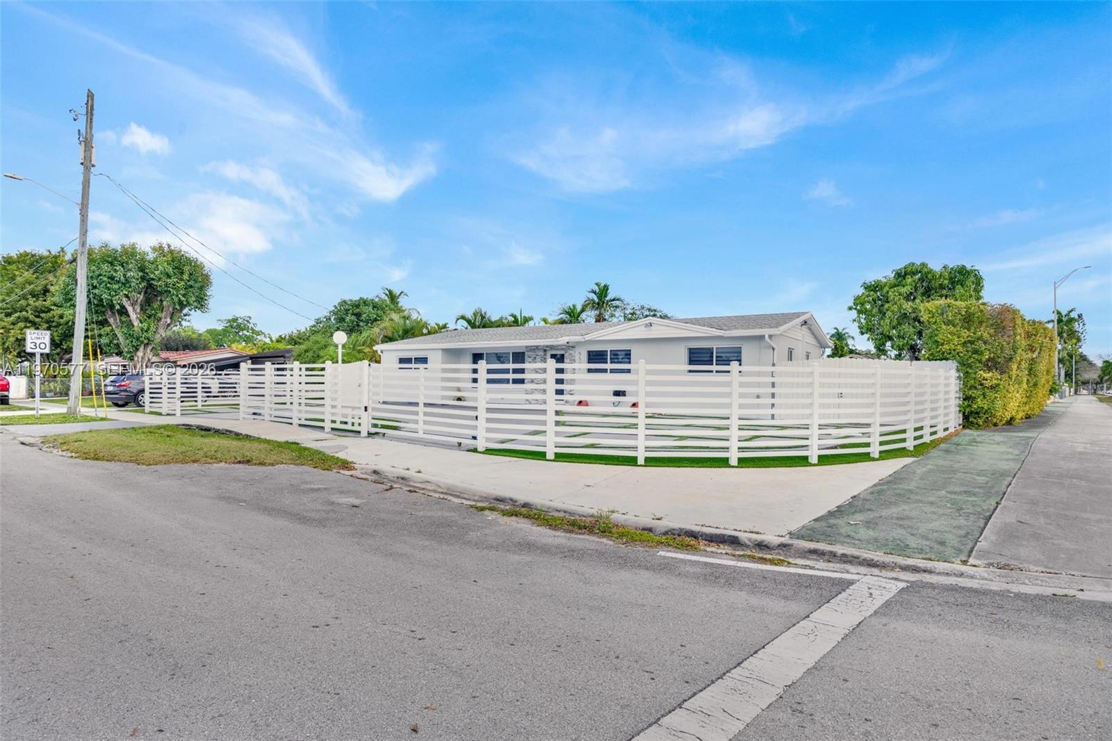 A single-story house with a white horizontal fence sits on a corner lot — 5521 SW 104th Ave, Miami FL 33165, MIAMI, FL
