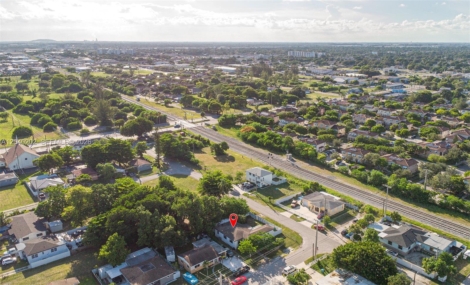 An aerial view shows a residential neighborhood with a house marked by a red pin — 7190 NW 21st Ave, Miami FL 33147, MIAMI, FL